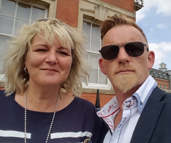 Georgina and Andrew smile at the camera - Shared Lives PSS UK